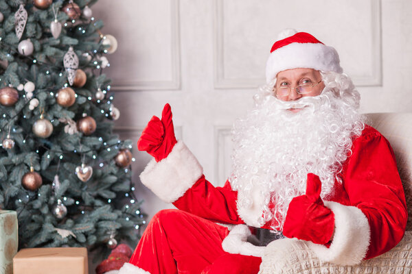 Cheerful Santa Claus is congratulating with New Year