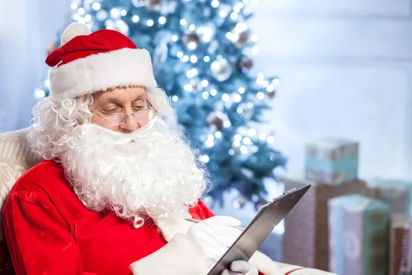 Happy Father Christmas is preparing for giving presents — Stok fotoğraf