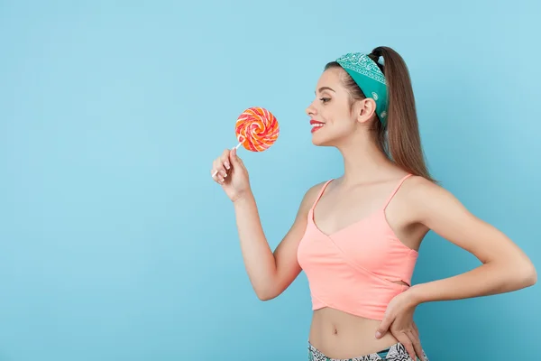 Beautiful young hipster girl is eating lollipop — 스톡 사진