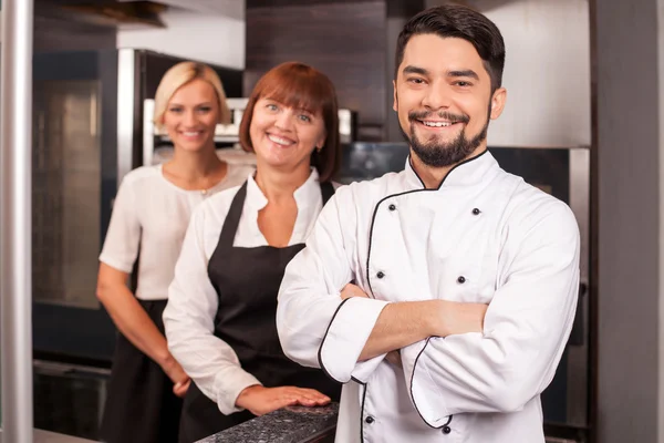 Professional friendly chefs are working in bakery — Stock Photo, Image