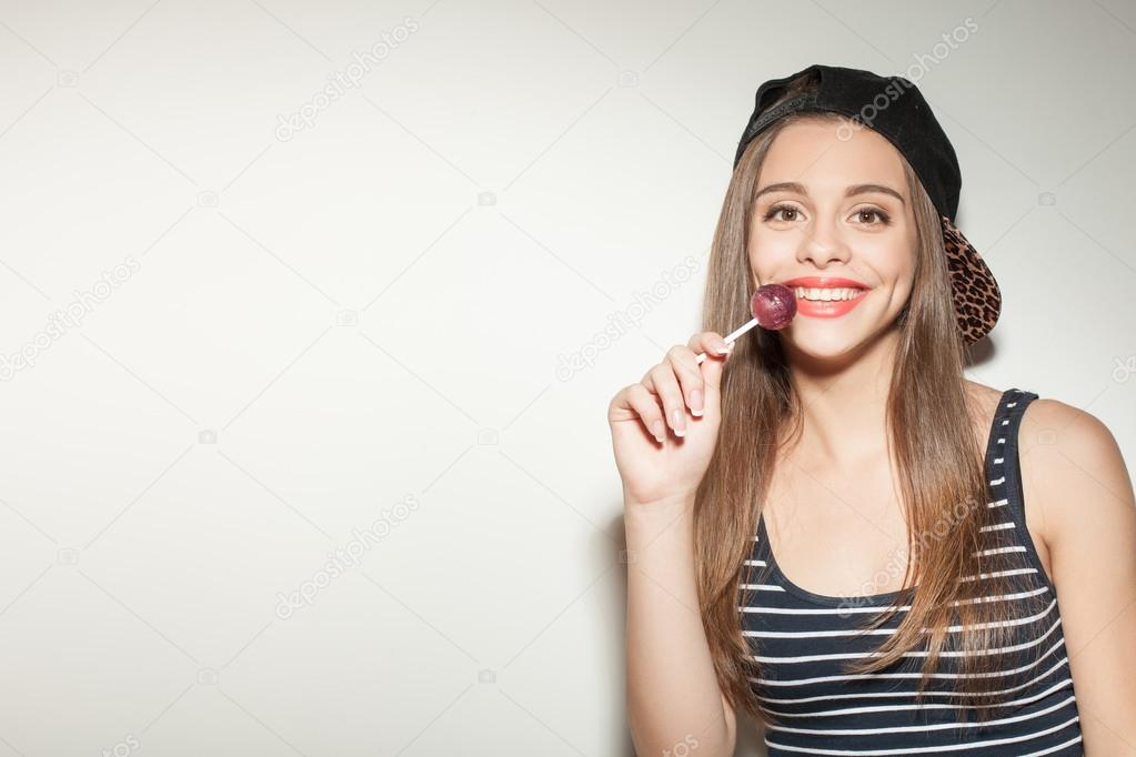 Attractive young girl is enjoying sweet candy
