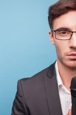 Attractive young male reporter is working with equipment
