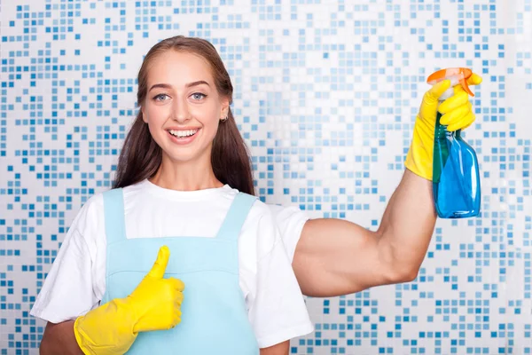 Beautiful young female cleaner is doing clean-up — 스톡 사진