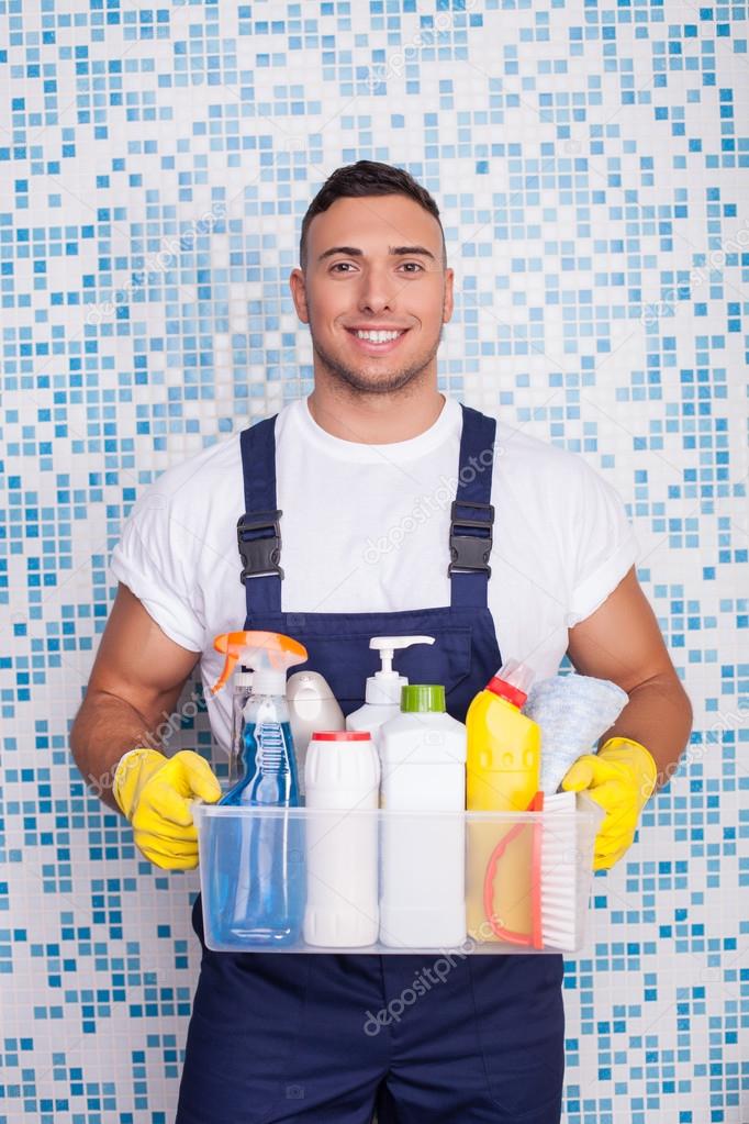 Attractive young stay-at-home man is cleaning his house