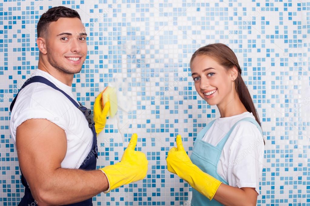 Cute young man and woman are doing clean-up