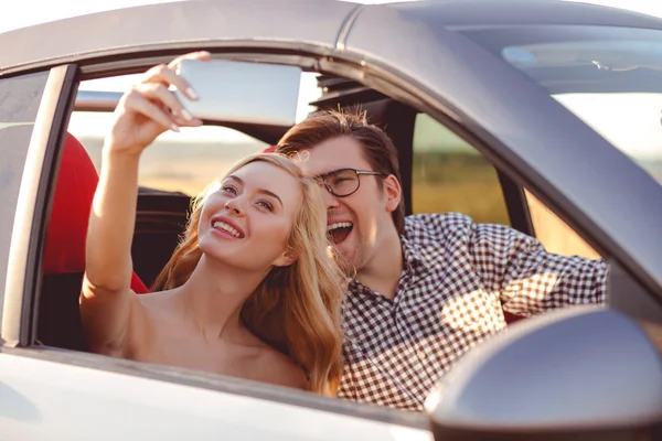 Beautiful loving couple is photographing themselves in transport — Stock Photo, Image