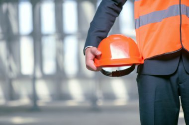 Cheerful young architect is working in special clothing