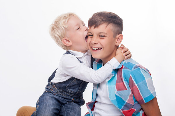 Cheerful friendly brothers are making fun together