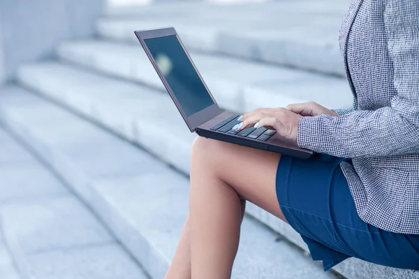 Professional young female worker is using a laptop — Stock Photo, Image