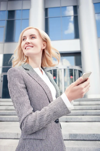 Cheerful young woman is using telephone for communication — Stock fotografie