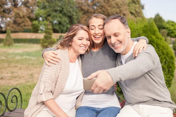 Alegre familia amistosa está haciendo selfie en la naturaleza — Foto de Stock