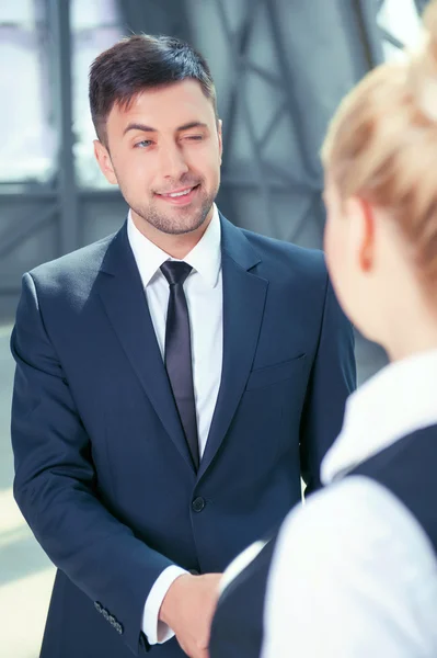 Handsome young businessman is congratulating his colleague — Stock Photo, Image