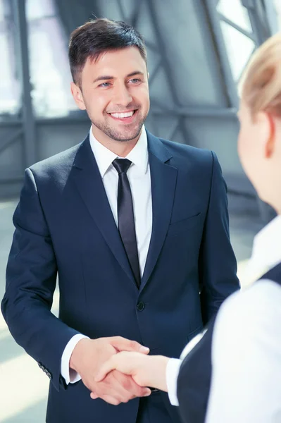 Attractive man in suit receives handshake from his colleague — Stock Photo, Image