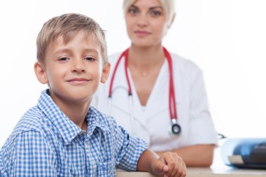 Cheerful small child is attending his doctor