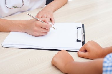 Processional young doctor is analyzing disease of child