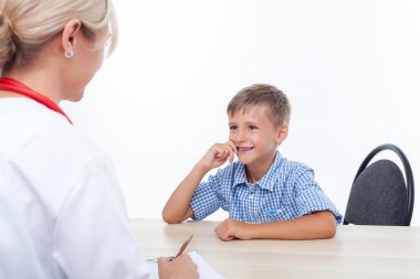 Cheerful small child is visiting his doctor