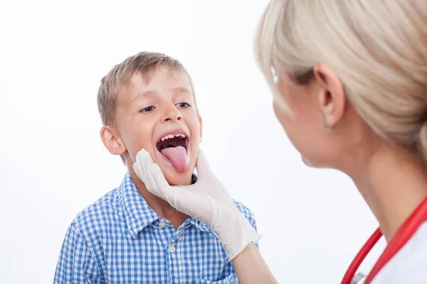 Cheerful female doctor is checking the health of child — Stok fotoğraf