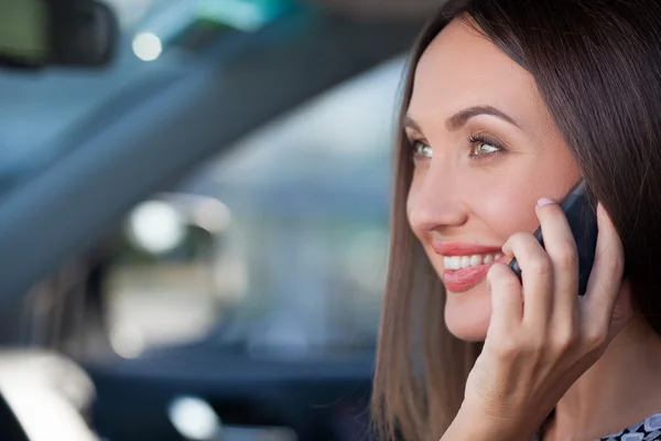 Beautiful young businesswoman is using telephone in transport — ストック写真