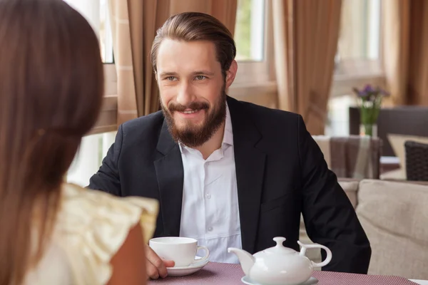 Cheerful young loving couple is meeting in cafe — Stock Photo, Image