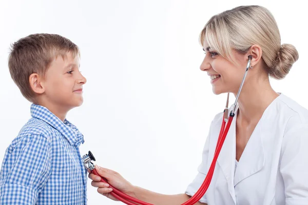 Beautiful young female pediatrician is seeing her patient Stock Image