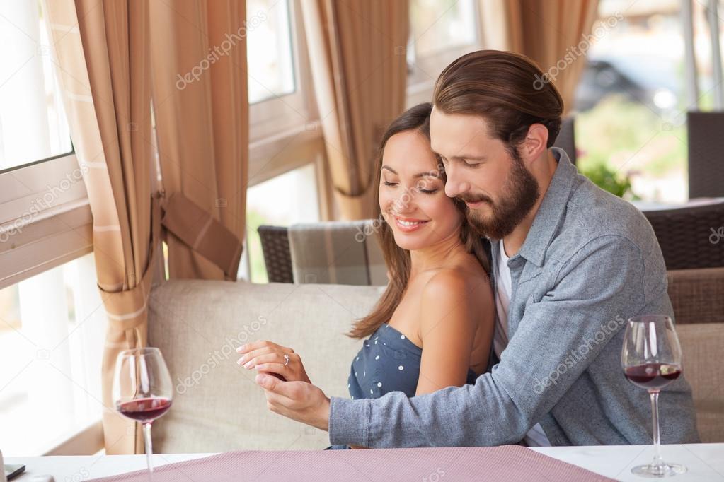Cheerful young loving couple is resting in restaurant