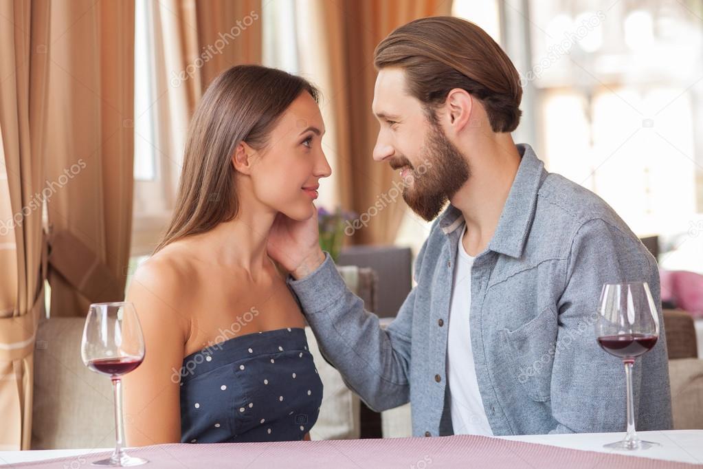 Attractive young loving couple is relaxing in restaurant