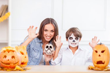 Pretty mother and son are having fun on Halloween