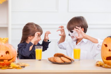 Cheerful children are making fun in Halloween