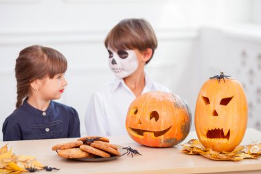 Cheerful siblings are decorating food before Nut-Crack Night