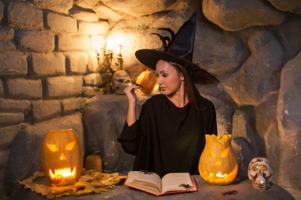Beautiful young female wizard is practicing witchcraft
