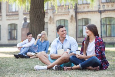 Attractive friendly students are resting after lessons