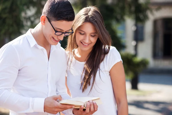 Attractive young man and woman are preparing for exam — Stock Fotó