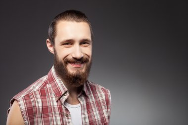 Cheerful young bearded guy is expressing positive emotions