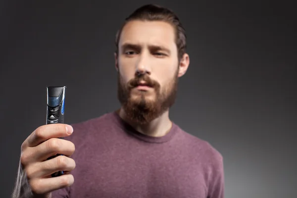 Cheerful guy with beard is thinking about shaving — 스톡 사진