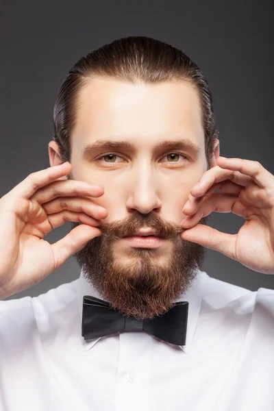 Красивый молодой бородатый парень заботится о своей внешности — стоковое фото