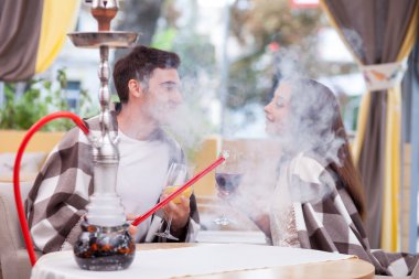Beautiful boyfriend and girlfriend are resting in restaurant