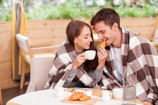Cheerful young loving couple is enjoying tea in cafe — Stockfoto