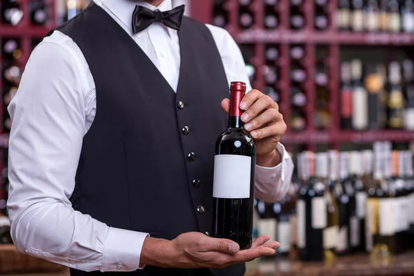 Professional young sommelier is working in liquor store — Zdjęcie stockowe