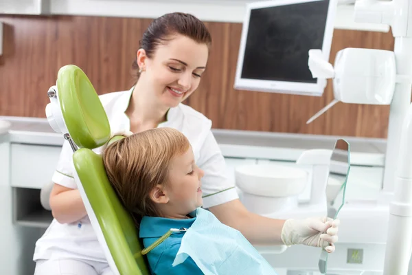 Cute male child is satisfied with work of dental doctor — Φωτογραφία Αρχείου