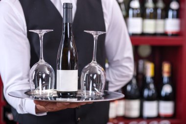 Professional male sommelier is serving alcohol drink
