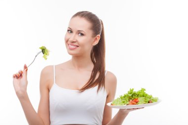 Attractive fit girl is dieting with shopped vegetables