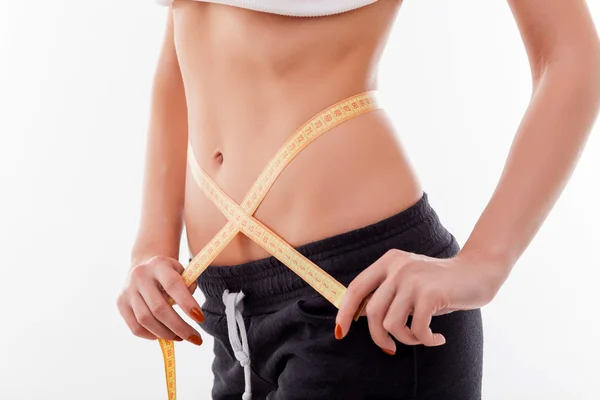 Cheerful healthy woman with tape-measure is caring of body — 스톡 사진