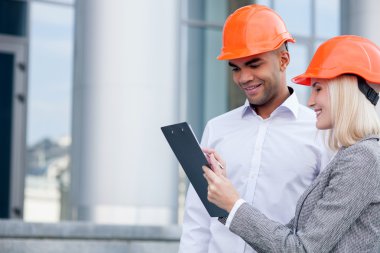 Cheerful young architects are planning new project