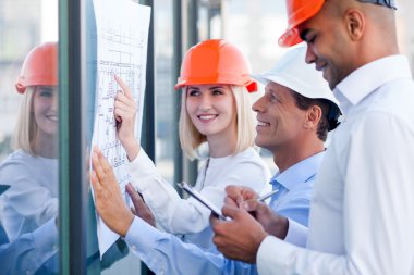 Skillful three architects are planning new construction