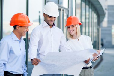 Cheerful young architect are working on new project