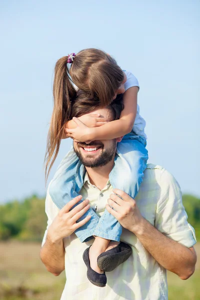 Cheerful man and child are playing in park — Stock Photo, Image