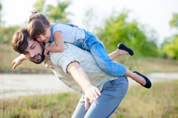 Cheerful parent and child are making fun in park — ストック写真