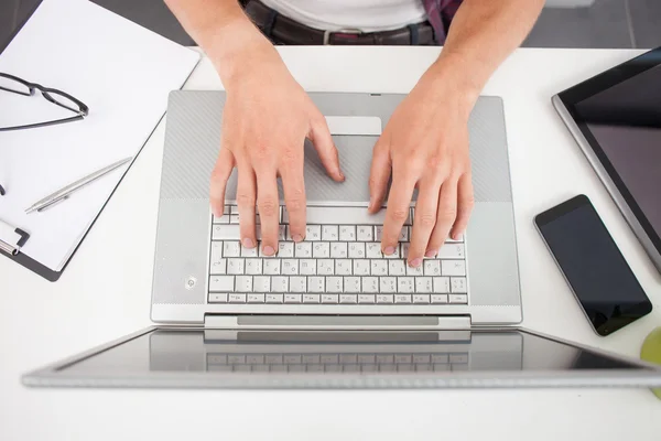 Hard working process with laptop at table — Stockfoto