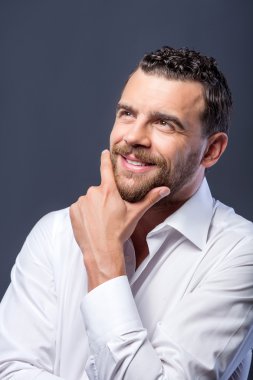 Attractive bearded businessman is thinking about his future