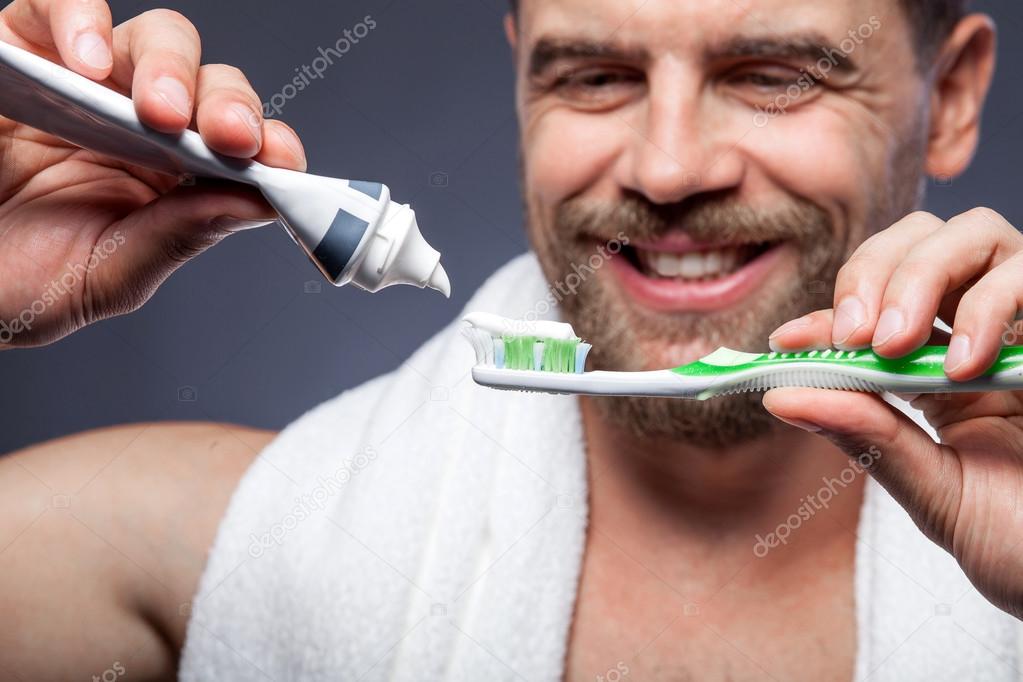 Process of toothbrushing for guy in the morning